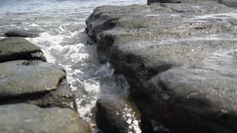 Rock and waves at the shore of pandami island Stock Footage