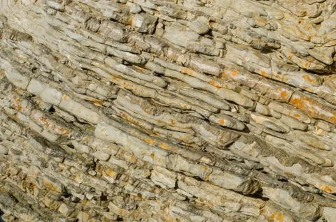 Rock, the background of the layers of ancient sediments. Stock Photos