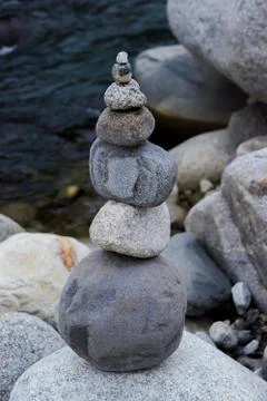Rock Balancing having flowing river in the background Fotos de archivo