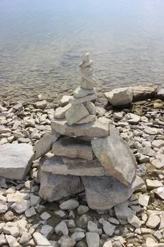 Rock balancing (or stone balancing) figure on lake shore Stock Photos