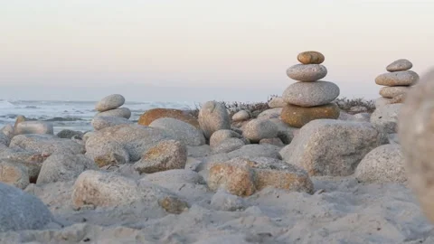 Rock balancing on pebble beach. Pyramid stacks of stones, ocean coast, sea water Stock Footage 226195060