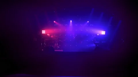 Rock band performs on stage with a light show Stock Footage 194546571