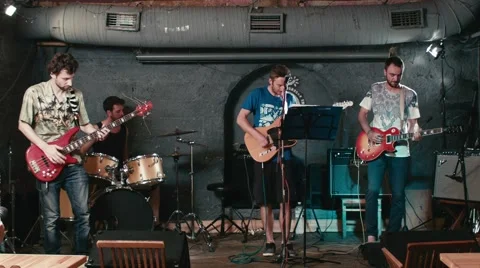 Rock band performs in underground pub Stock Footage 64996840