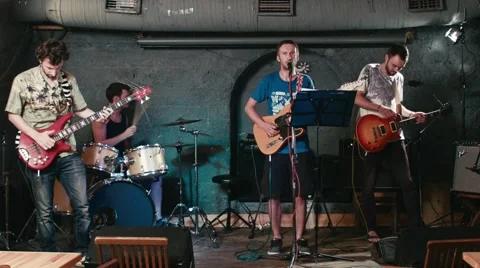 Rock band performs in underground pub Stock Footage 64996975