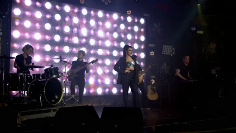 A rock band on stage begins a performance with a light show Stock Footage 194546019