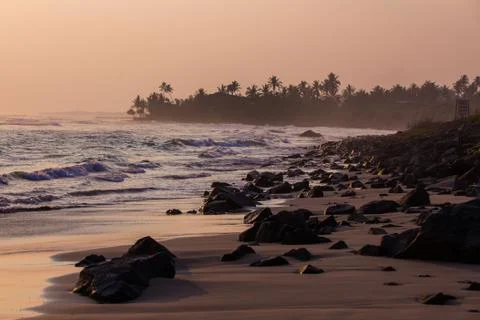 Rock beach at sunset Stock Photos