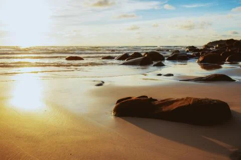 Rock on beach at sunset. Stock-Fotos