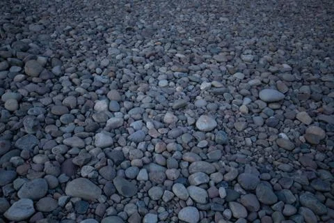 Rock bed pebbles pattern on beach Stock Photos