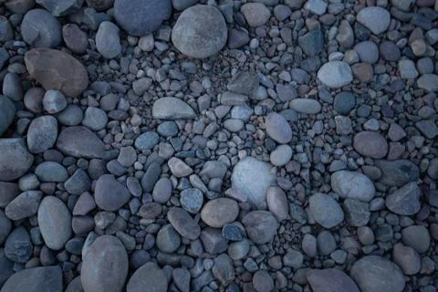 Rock bed pebbles pattern on beach Stock Photos