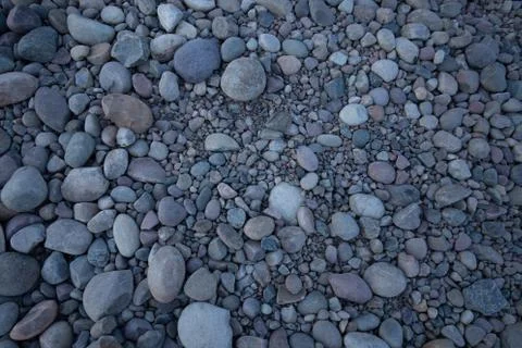 Rock bed pebbles pattern on beach Stock Photos