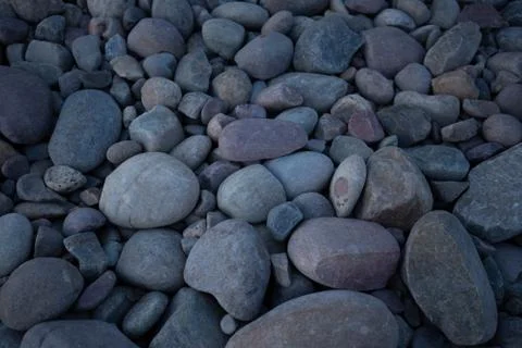 Rock bed pebbles pattern on beach Stock Photos