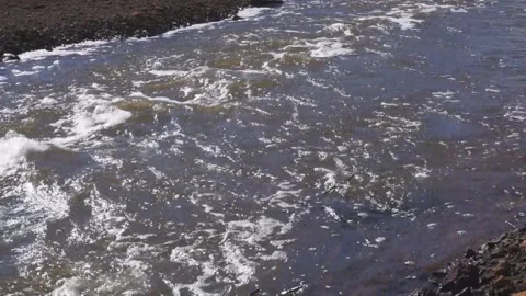 A rock bed in a shallow part of the river Shallow Rapids A river bed, clean and  Stock Footage 95033616