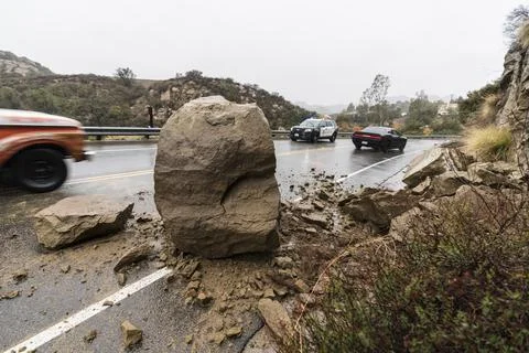 Rock Blocking Road with Traffic Stock Photos