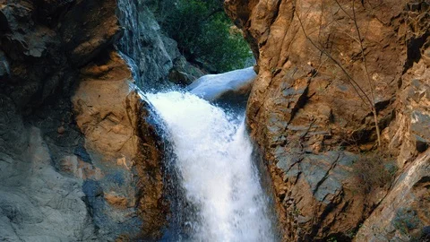 Rock blocking waterfall. Action in wild nature. Wild waterfall close up. 4k Stock Footage 105418471