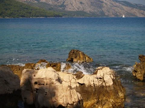 Rock in blue waves Stock Photos