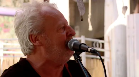 Rock &amp; blues singer performs at outdoor beach bar concert, Stock Footage 40381418