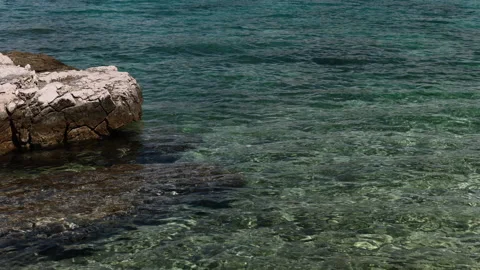 Rock Breaking the Surface in the Adriatic Sea of the Coast of Jerolim, Croatia Stock Footage 237725606