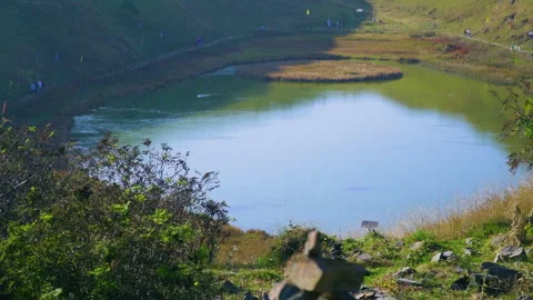 Rock Cairn Stack Overlooking Serene Prashar Lake in Indian Himalayas Stock Footage 347054055