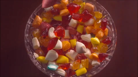 Rock candies fall down into a crystal plate in slow motion Stock Footage 147225550