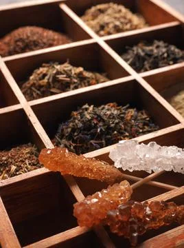 Rock candy with different kinds of tea in the wooden box Stock Photos