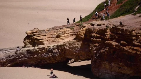 Rock with a cave on a beach Stock Footage 250981542