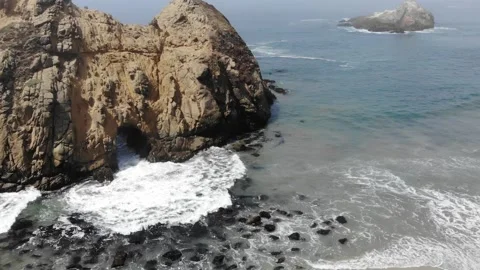Rock Cave at Beach Getting Hit By Ocean Waves in Slow Motion Stock Footage 142317494