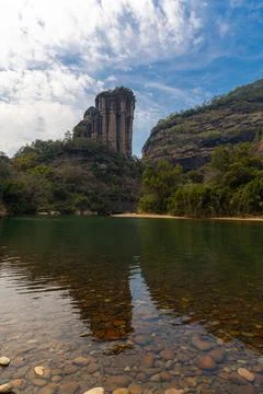Rock cliff lining the nine bend river or Jiuxi in Wuyishan scenic area in Chi Stock Photos