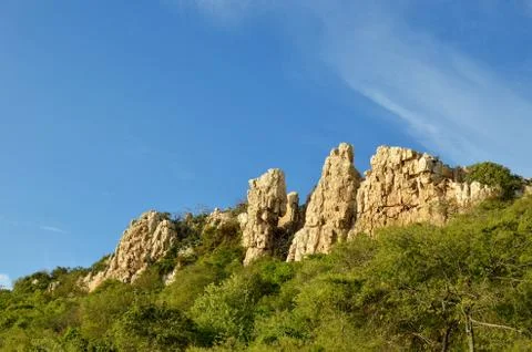 Rock by cliff Stock Photos