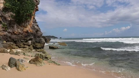Rock cliffs on the beach. Tropical Beach Waves. Rough Ocean Waves Stock Footage 166823413