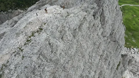 A rock climber arriving at the summit of the mountain Stock Footage 262531843
