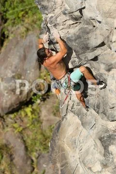Rock Climber Climb Up A Cliff Stock Photos