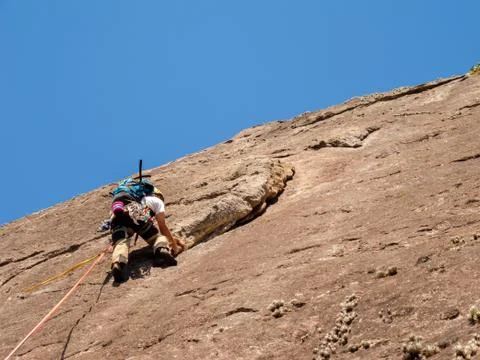 Rock climber climbing a sloping rock wall in Brazil Stock Photos