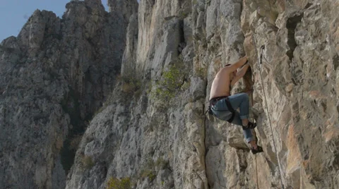 Rock climber climbs behing corner HD Stock Footage 33531233