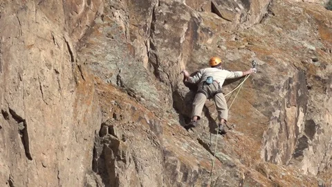 Rock climber climbs difficult route Stock Footage 74600863