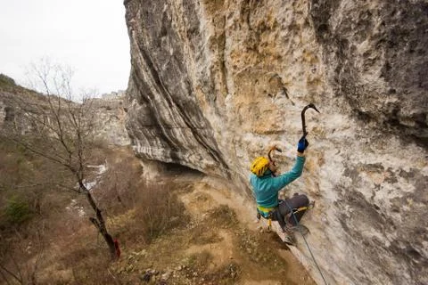 Rock climber climbs mountain with tools Stock Photos