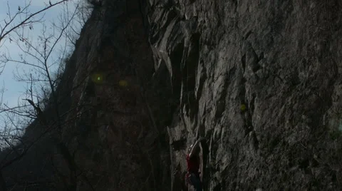 Rock climber climbs steep granite crag Stock Footage 48618223
