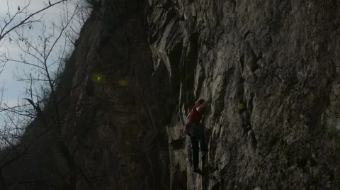 Rock climber climbs steep rock face Stock Footage 48618294