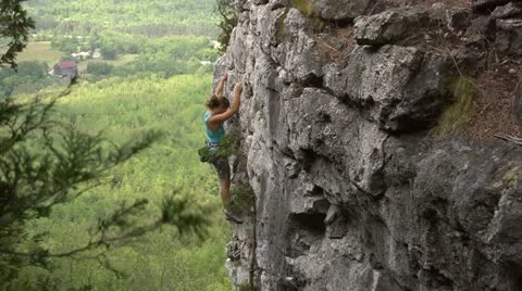 Rock climber close to the top Stockbeeldmateriaal 22304632