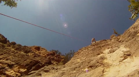 Rock climber descending on a rope Stock Footage 58433299