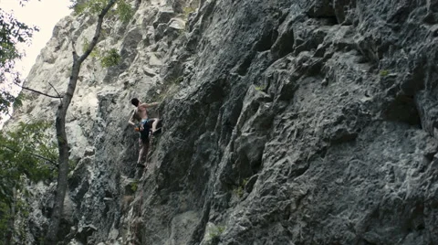Rock climber does difficult move Stock Footage 43386481
