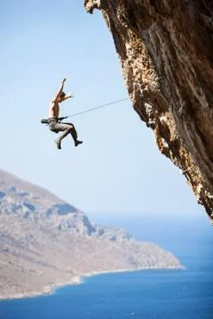 Rock climber falling of a cliff while lead climbing Stock Photos