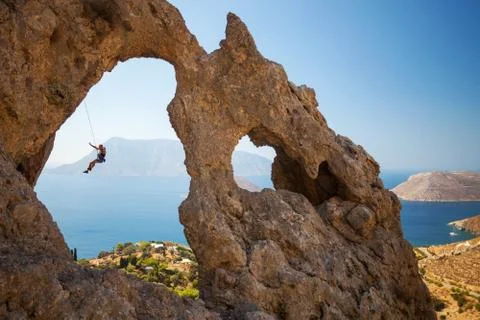 Rock climber falling of a cliff while lead climbing. Stock Photos