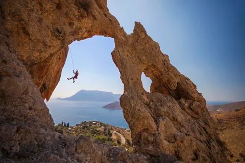 Rock climber falling of a cliff while lead climbing. Stock Photos