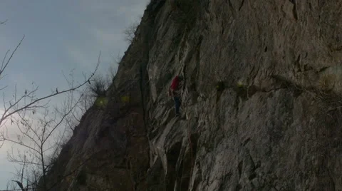 Rock climber gets to top of route and sets up anchor Stock Footage 48617995