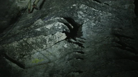 Rock Climber Going Down Cliff Wall At Night Stock Footage 64309542