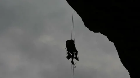 Rock climber hanging in space backlight Video stock 43811869