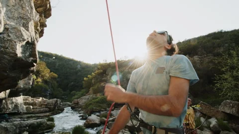 Rock Climber Preparing for Ascent in Sunlit Canyon, Simple ProRes Shot Stock Footage 272626020