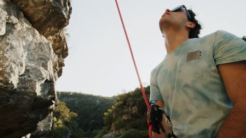 Rock Climber Preparing for Ascent in Sunlit Canyon, Simple ProRes Shot Stock Footage 272818235