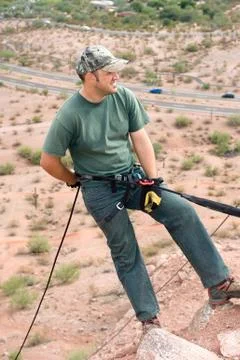 Rock climber rapelling Stock Photos