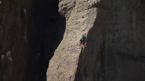 Rock climber scaling a sunlit cliff at Smith Rock State Park Oregon Stock Footage 346794795